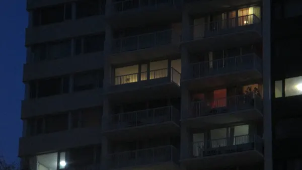 Apartment patios in the night with a few lights on