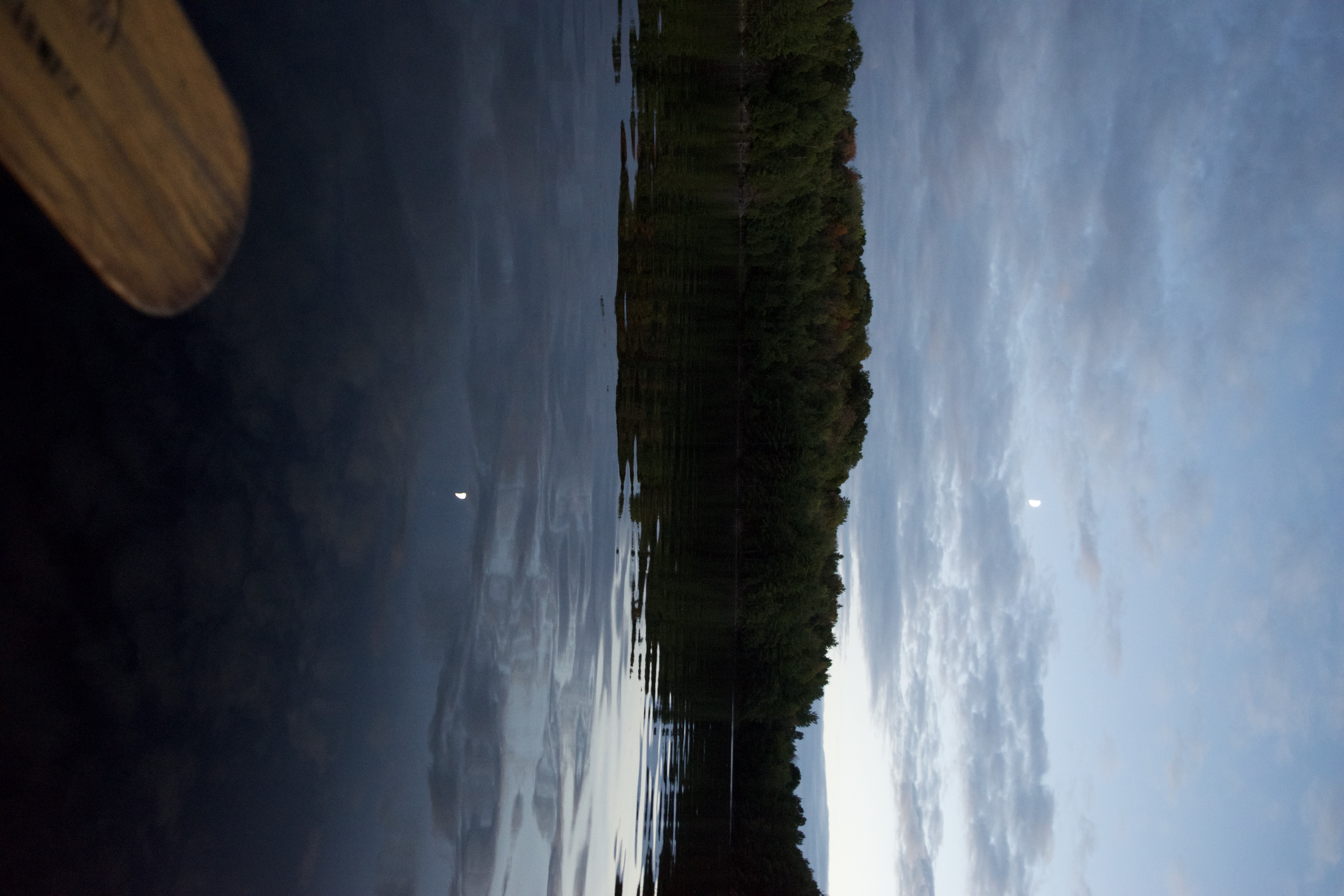 Image from the perspective of inside a canoe of a sunset