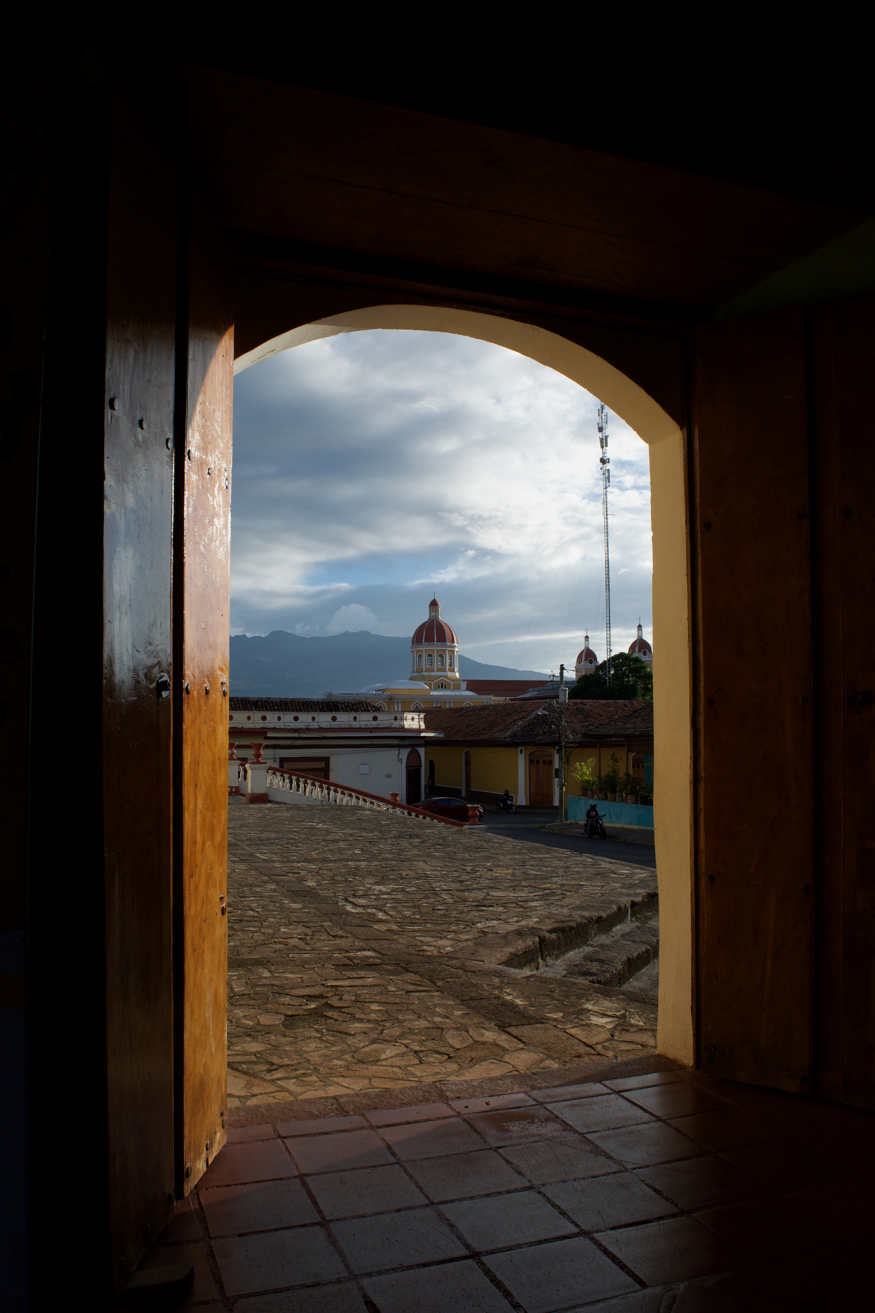 An image of a cathedral in the distance through a wooden doorframe