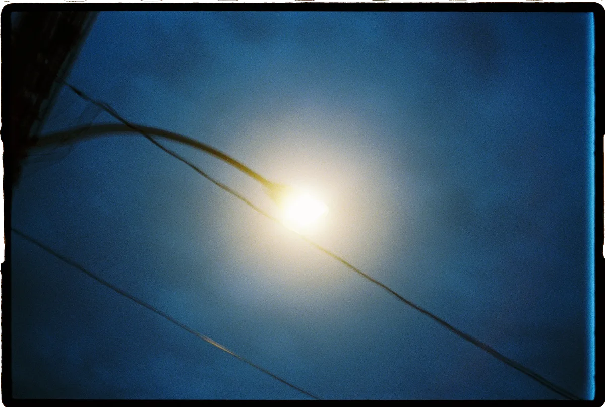 A street lamp infront of a dark night sky