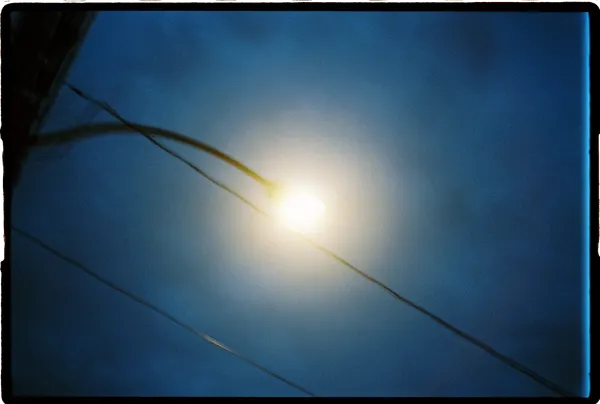 A street lamp infront of a dark night sky