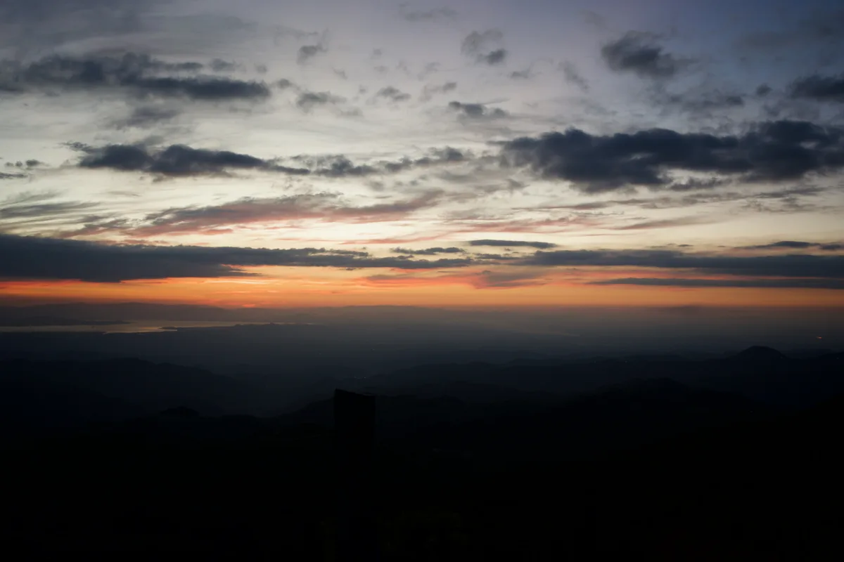 A sunet over many small mountains