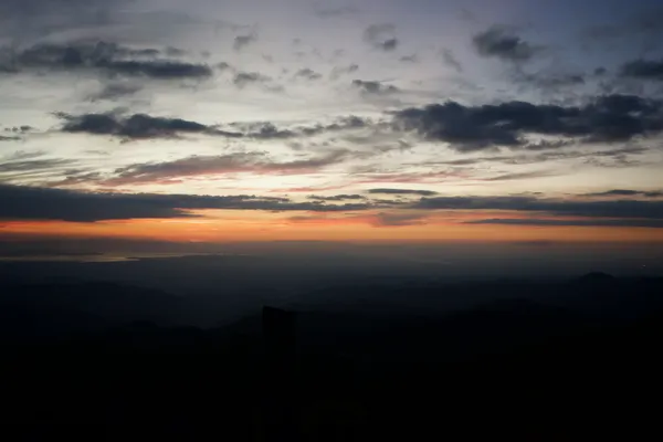 A sunet over many small mountains
