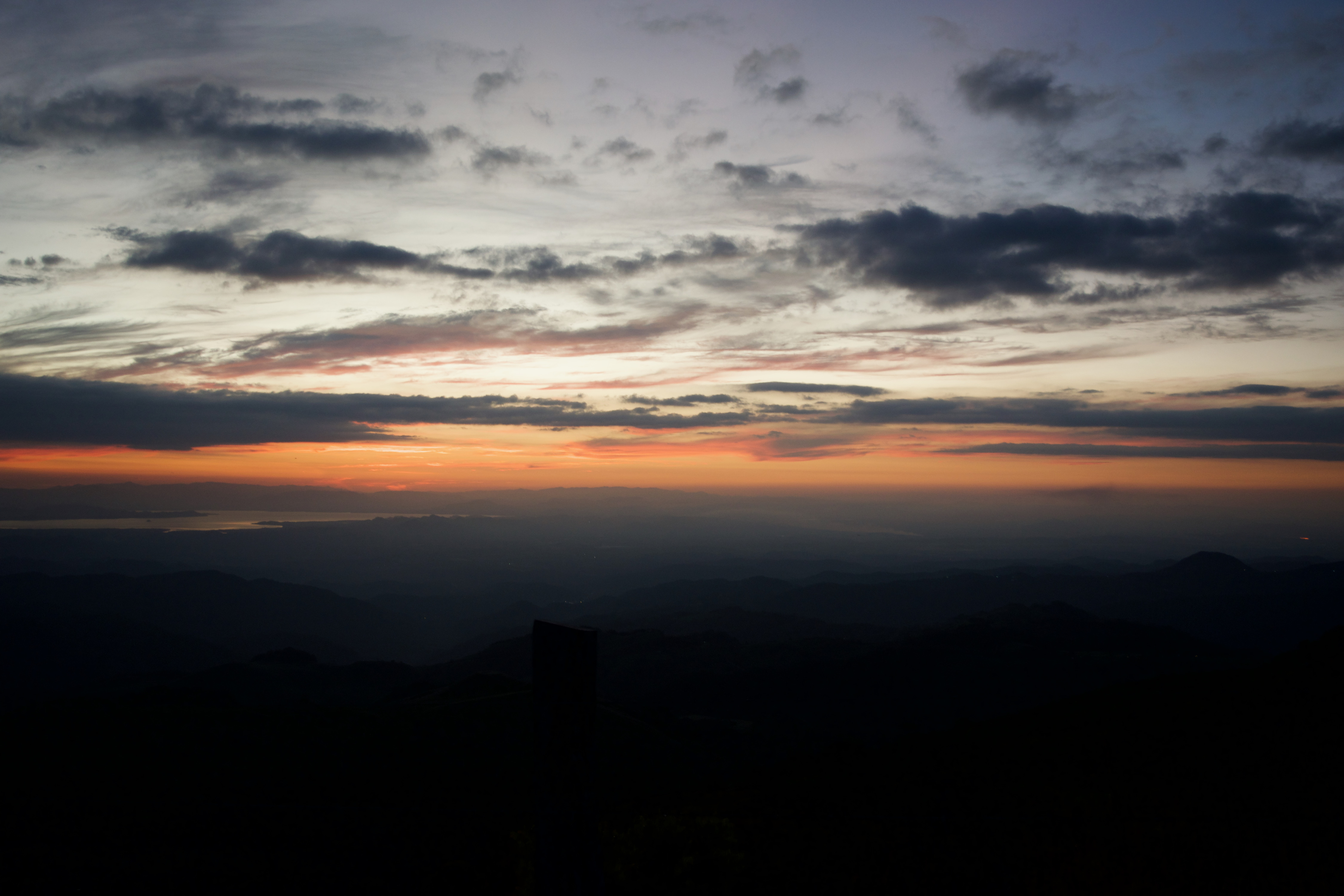 A sunet over many small mountains