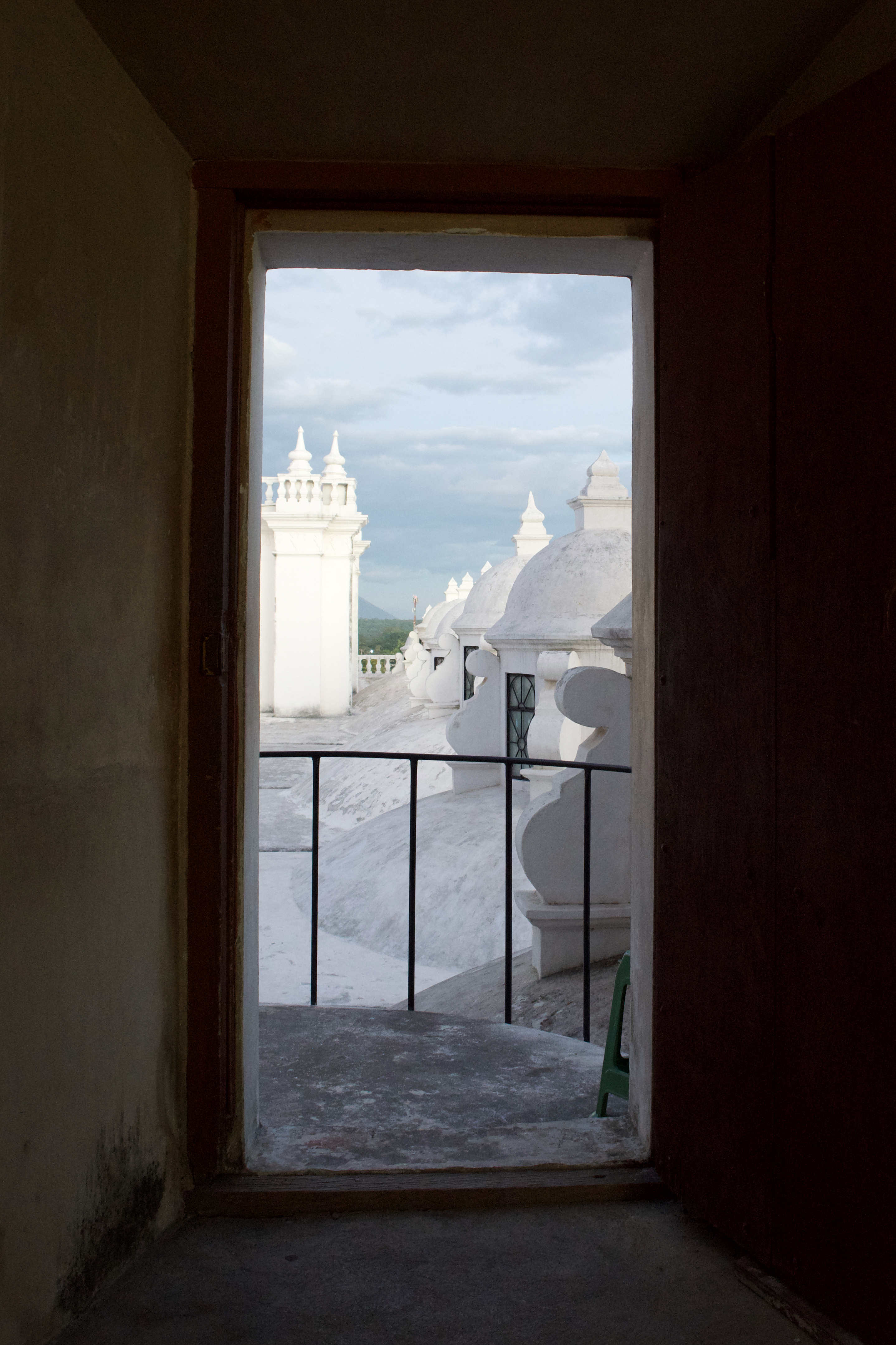 A doorframe leading to a white ornate roof